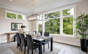 Modern dining room with big windows and beautiful green view