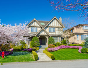Big custom made luxury house with nicely trimmed and landscaped front yard